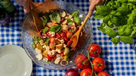 Zucchini-Pommes in einer Schüssel mit Gewürzschälchen drumherum