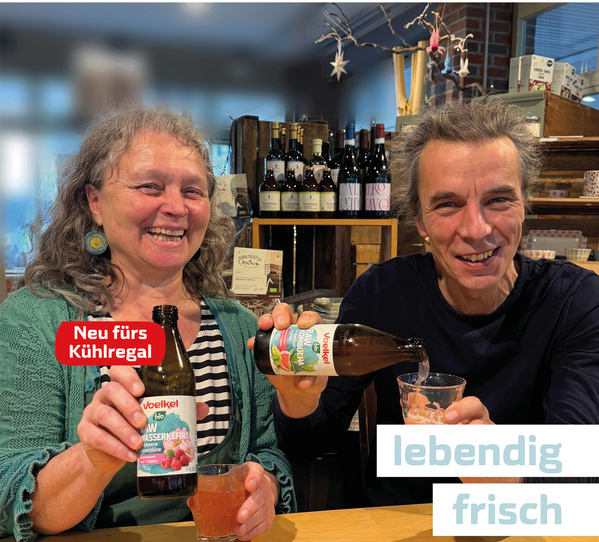 Zwei lächelnde Personen schenken Getränk ein. Text: "Neu fürs Kühlregal." "lebendig frisch."